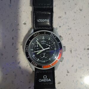 Omega Black Swatch Chronograph Watch with Orange Bezel Accent